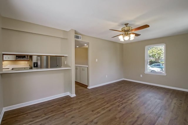 5831 Durbridge Dr, New Orleans, LA 70131 - unfurnished living room featuring a ceiling fan, dark wood-type flooring, and baseboards