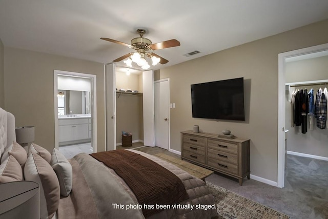 5831 Durbridge Dr, New Orleans, LA 70131 - bedroom with a walk in closet, a closet, ensuite bathroom, light carpet, and baseboards