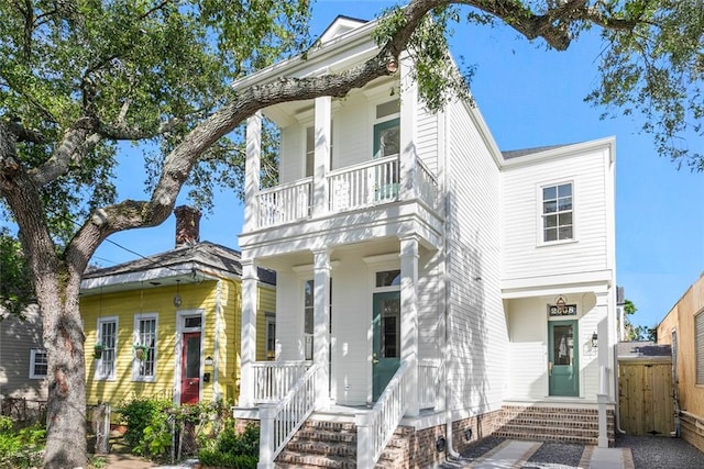 2508 Laurel St, New Orleans, LA 70130 - view of front of home featuring a balcony, a porch, and fence