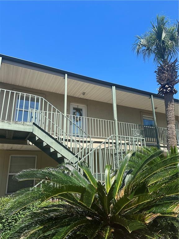 3725 Marion St Unit 5, Metairie, LA 70002 - view of property exterior featuring stucco siding, stairway, and a porch