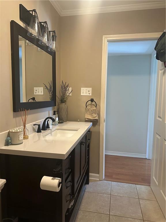 3725 Marion St Unit 5, Metairie, LA 70002 - bathroom featuring tile patterned flooring, crown molding, vanity, and baseboards