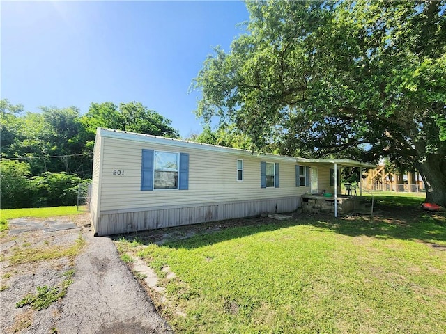201 Caroline Ave, Port Sulphur, LA 70083 - manufactured / mobile home featuring a front yard and driveway