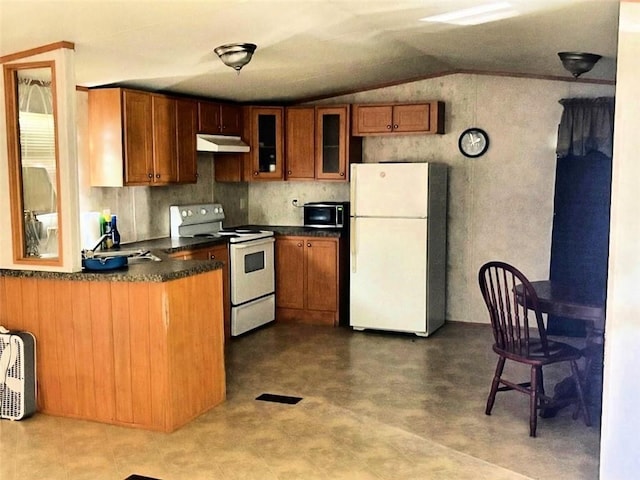 201 Caroline Ave, Port Sulphur, LA 70083 - kitchen featuring white appliances, under cabinet range hood, brown cabinets, lofted ceiling, and dark countertops
