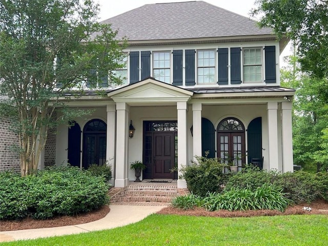 7 Spanish Moss Ct, Mandeville, LA 70471 - view of front of home featuring french doors, a porch, and a shingled roof
