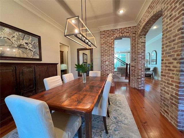 7 Spanish Moss Ct, Mandeville, LA 70471 - dining space featuring arched walkways, wood-type flooring, decorative columns, and crown molding