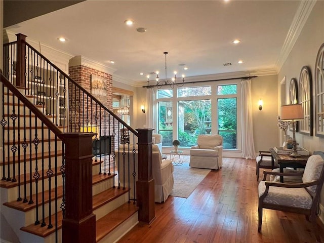 7 Spanish Moss Ct, Mandeville, LA 70471 - stairs featuring a chandelier, wood-type flooring, ornamental molding, and recessed lighting