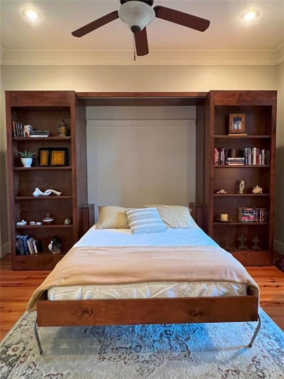 7 Spanish Moss Ct, Mandeville, LA 70471 - bedroom featuring wood finished floors, ornamental molding, and a ceiling fan