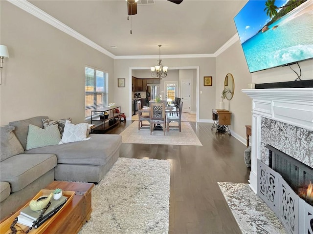 629 High Ridge Loop, Slidell, LA 70458 - living room with a premium fireplace, wood finished floors, ornamental molding, a ceiling fan, and a chandelier