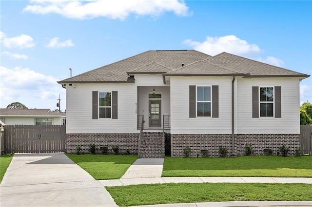 5128 Cunningham Ct, New Orleans, LA 70126 - view of front of home featuring a gate, brick siding, concrete driveway, and roof with shingles