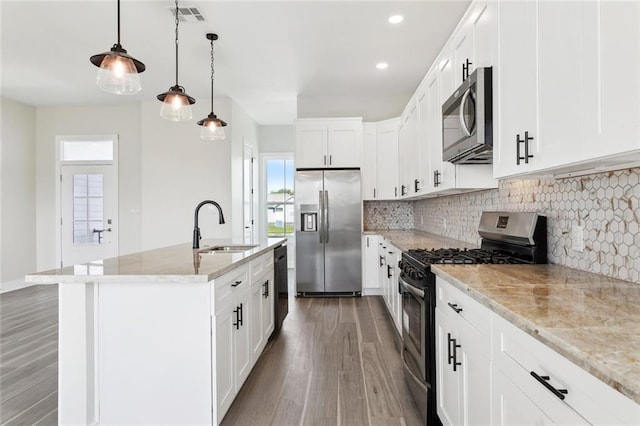 5128 Cunningham Ct, New Orleans, LA 70126 - kitchen with stainless steel appliances, a sink, light wood-style flooring, backsplash, and light stone counters