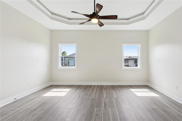 5128 Cunningham Ct, New Orleans, LA 70126 - empty room featuring a raised ceiling, healthy amount of natural light, and wood finished floors