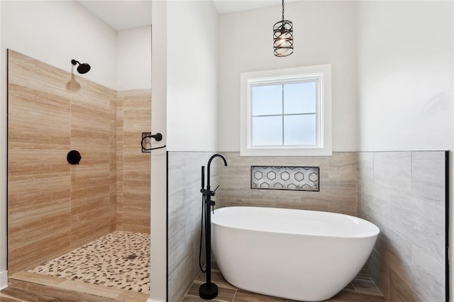 5128 Cunningham Ct, New Orleans, LA 70126 - full bathroom featuring tiled shower, a freestanding tub, tile walls, and wainscoting