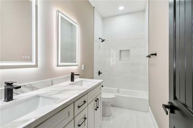 3821 Indiana St, New Orleans, LA 70114 - bathroom featuring marble finish floors, toilet, double vanity, washtub / shower combination, and baseboards