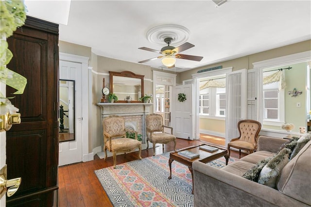 627 Ursulines Ave Unit 9, New Orleans, LA 70116 - living area with a ceiling fan, baseboards, hardwood / wood-style floors, and a fireplace
