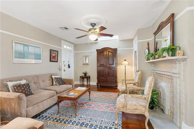 627 Ursulines Ave Unit 9, New Orleans, LA 70116 - living area with ceiling fan, wood finished floors, a fireplace, and baseboards
