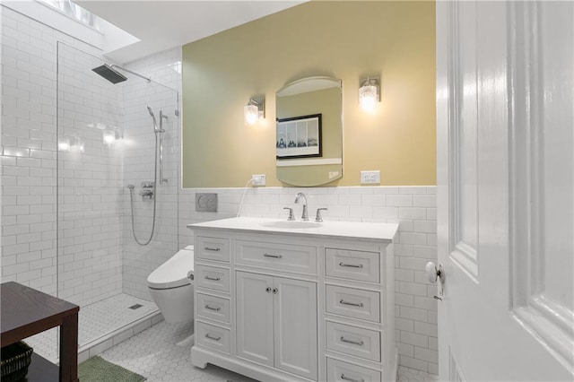 627 Ursulines Ave Unit 9, New Orleans, LA 70116 - full bath featuring tile walls, tile patterned floors, tiled shower, a wainscoted wall, and vanity
