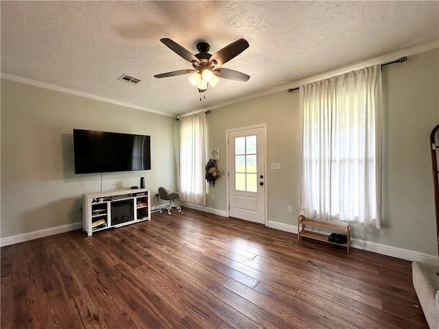 24473 Timbercrest Dr, Franklinton, LA 70438 - unfurnished living room with a textured ceiling, dark wood-type flooring, a ceiling fan, ornamental molding, and baseboards