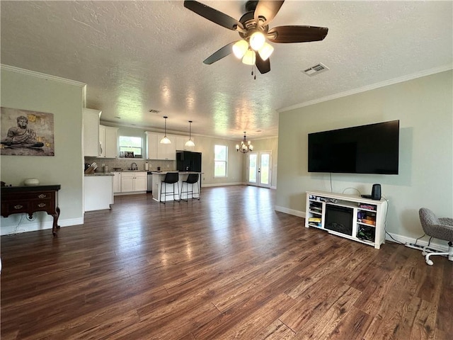 24473 Timbercrest Dr, Franklinton, LA 70438 - living area with dark wood-style floors, a chandelier, a textured ceiling, a ceiling fan, and ornamental molding