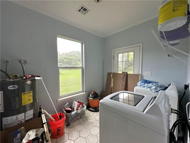 24473 Timbercrest Dr, Franklinton, LA 70438 - clothes washing area featuring washer and clothes dryer, water heater, ornamental molding, and light tile patterned floors