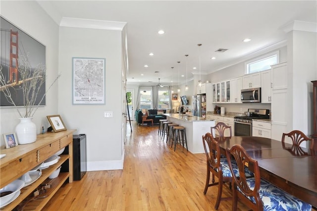 1723 N Broad St, New Orleans, LA 70119 - dining room with light wood-style flooring, recessed lighting, crown molding, baseboards, and ceiling fan