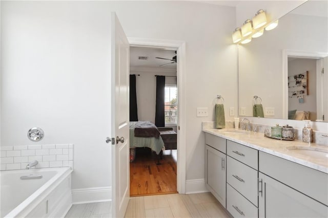 1723 N Broad St, New Orleans, LA 70119 - bathroom featuring connected bathroom, baseboards, double vanity, and a bath