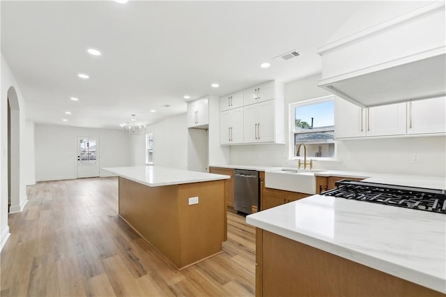 4412 Camel St, Metairie, LA 70001 - kitchen with stainless steel dishwasher, a sink, arched walkways, plenty of natural light, and recessed lighting