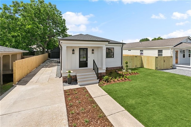 4412 Camel St, Metairie, LA 70001 - view of front facade with roof with shingles, board and batten siding, and driveway
