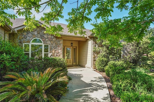 25506 Cardinal Ct, Bush, LA 70431 - view of exterior entry featuring stone siding and a shingled roof