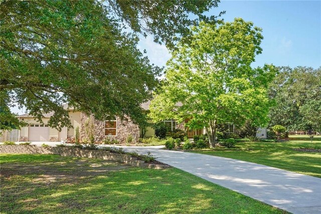 25506 Cardinal Ct, Bush, LA 70431 - view of front facade with a front lawn, a garage, and stone siding