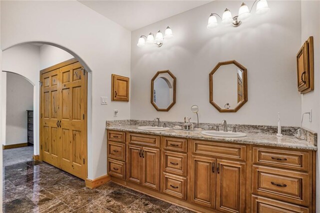 25506 Cardinal Ct, Bush, LA 70431 - bathroom featuring baseboards and double vanity