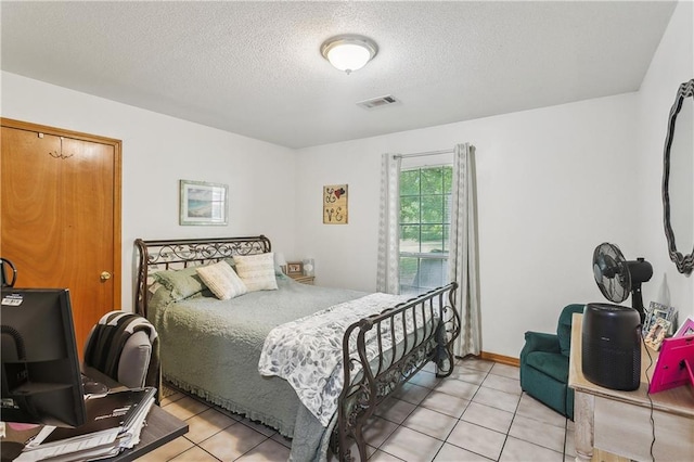 41357 Countryside Ln, Hammond, LA 70403 - bedroom featuring a textured ceiling and light tile patterned floors
