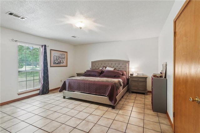 41357 Countryside Ln, Hammond, LA 70403 - bedroom featuring baseboards, light tile patterned floors, and a textured ceiling