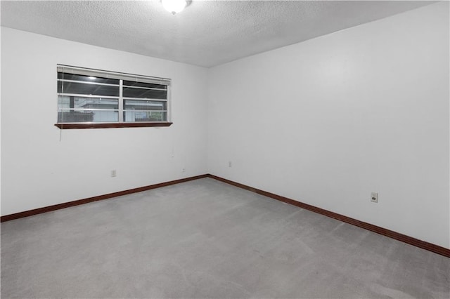 154 Oakwood Dr, Mandeville, LA 70448 - carpeted empty room with a textured ceiling and baseboards