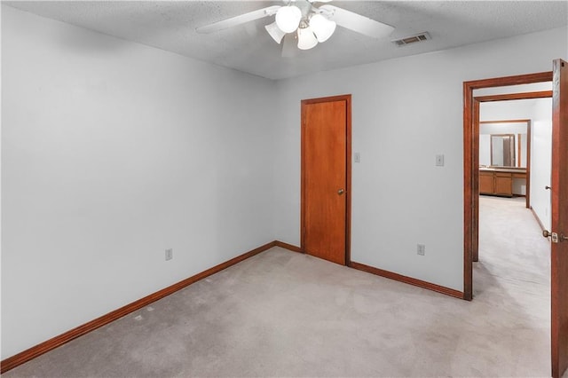 154 Oakwood Dr, Mandeville, LA 70448 - spare room featuring light carpet, a ceiling fan, baseboards, and a textured ceiling
