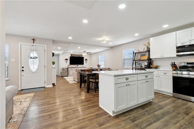 1931 Farmington Pl, Terrytown, LA 70056 - kitchen with stainless steel appliances, a ceiling fan, white cabinetry, a kitchen island, and recessed lighting