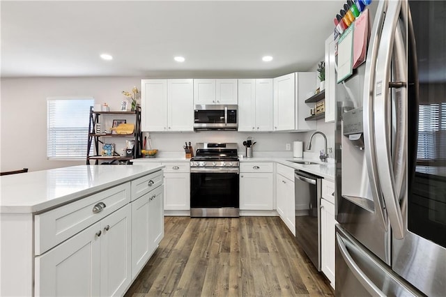 1931 Farmington Pl, Terrytown, LA 70056 - kitchen featuring appliances with stainless steel finishes, a sink, light countertops, wood finished floors, and white cabinets
