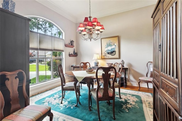 505 Swift Fox Run, Madisonville, LA 70447 - dining area featuring a chandelier, crown molding, wood finished floors, and baseboards