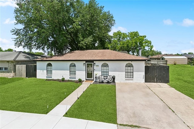 view of front of home featuring brick siding, concrete driveway, and a shingled roof