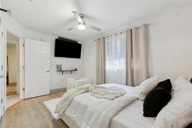 bedroom featuring light wood-style flooring and ceiling fan