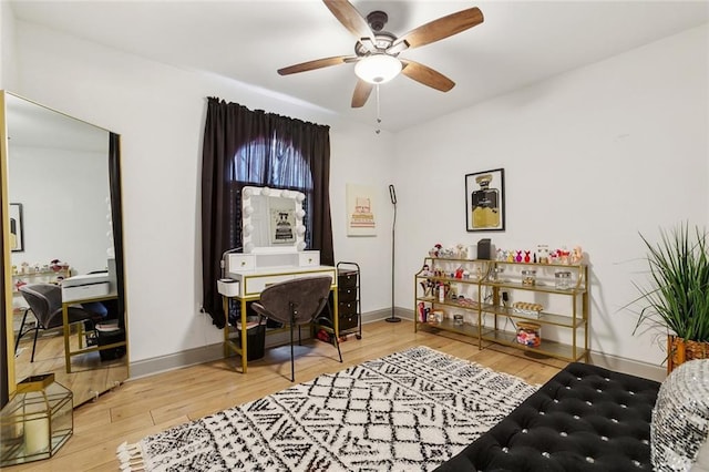 office featuring ceiling fan, wood finished floors, and baseboards