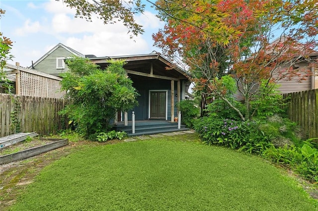 724 Constantinople St, New Orleans, LA 70115 - back of property with covered porch and a vegetable garden