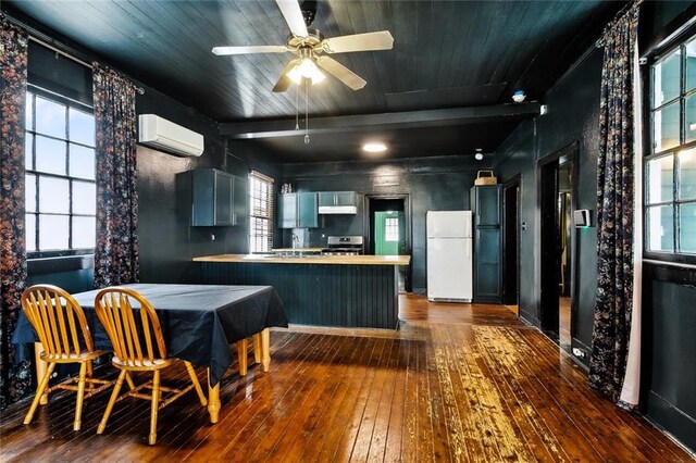 613 Pacific Ave, New Orleans, LA 70114 - kitchen with freestanding refrigerator, a wall unit AC, wood-type flooring, a peninsula, and wooden ceiling