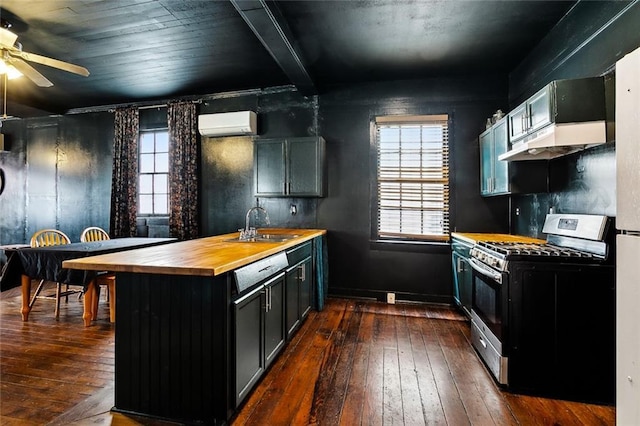 613 Pacific Ave, New Orleans, LA 70114 - kitchen with stainless steel gas range oven, a peninsula, butcher block countertops, a sink, and dark wood-style flooring