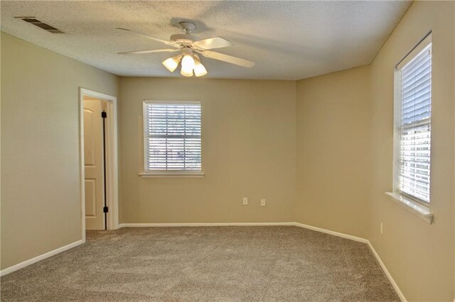 717 Heavens Dr Unit 4, Mandeville, LA 70471 - unfurnished room featuring carpet, a ceiling fan, baseboards, and a textured ceiling