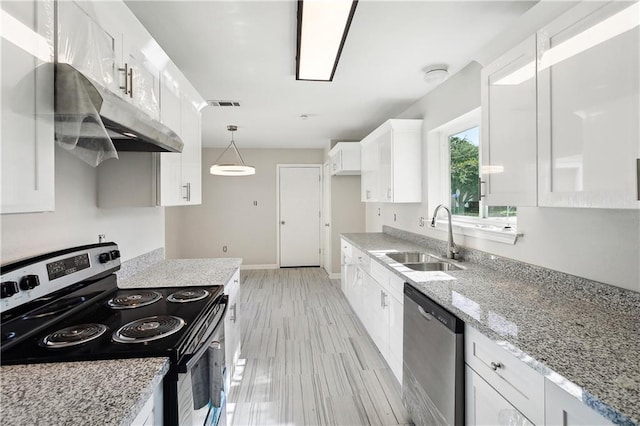 301 Holmes Dr, Slidell, LA 70460 - kitchen featuring appliances with stainless steel finishes, a sink, white cabinets, light stone counters, and under cabinet range hood