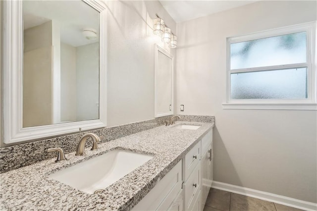 301 Holmes Dr, Slidell, LA 70460 - bathroom featuring baseboards, tile patterned flooring, and double vanity