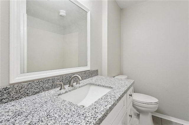 301 Holmes Dr, Slidell, LA 70460 - bathroom with vanity, toilet, tile patterned flooring, and baseboards