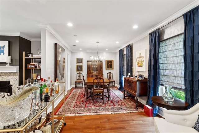 3928 Uri St, Metairie, LA 70002 - dining space featuring a chandelier, wood finished floors, plenty of natural light, recessed lighting, and ornamental molding