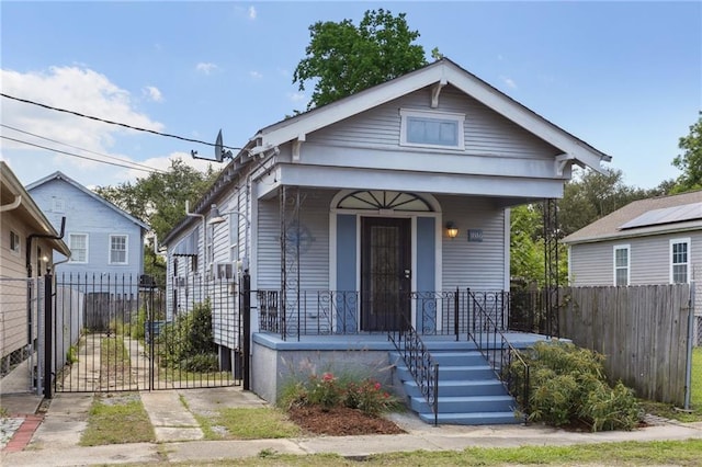 1816 Congress St, New Orleans, LA 70117 - shotgun-style home featuring covered porch, a gate, and fence