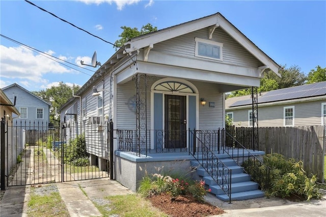 1816 Congress St, New Orleans, LA 70117 - shotgun-style home with covered porch, a gate, and fence